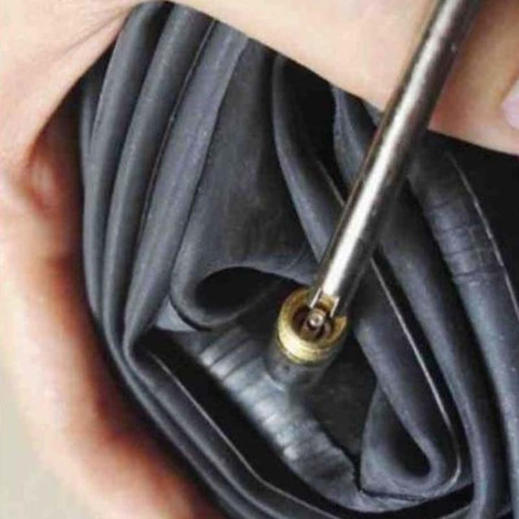 Valve core switch inserted into bicycle tire valve stem with metal tip