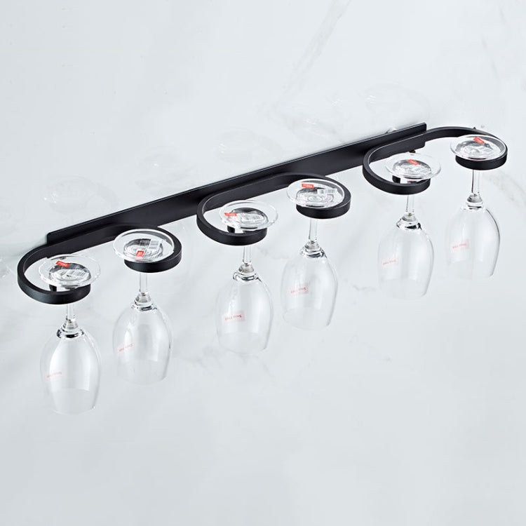 Black wine glass drying rack holding multiple inverted wine glasses on circular holders