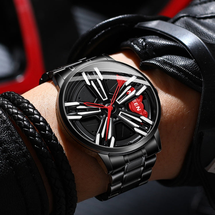 Men's black wheel-style metal watch on wrist with red dial accents and black bracelet