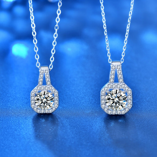 Two silver moissanite pendant necklaces with round center stones on link chains