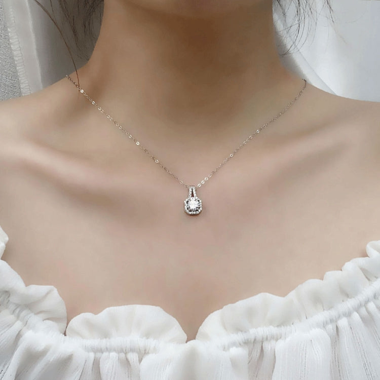 Moissanite pendant necklace on model with delicate chain and round halo centerpiece