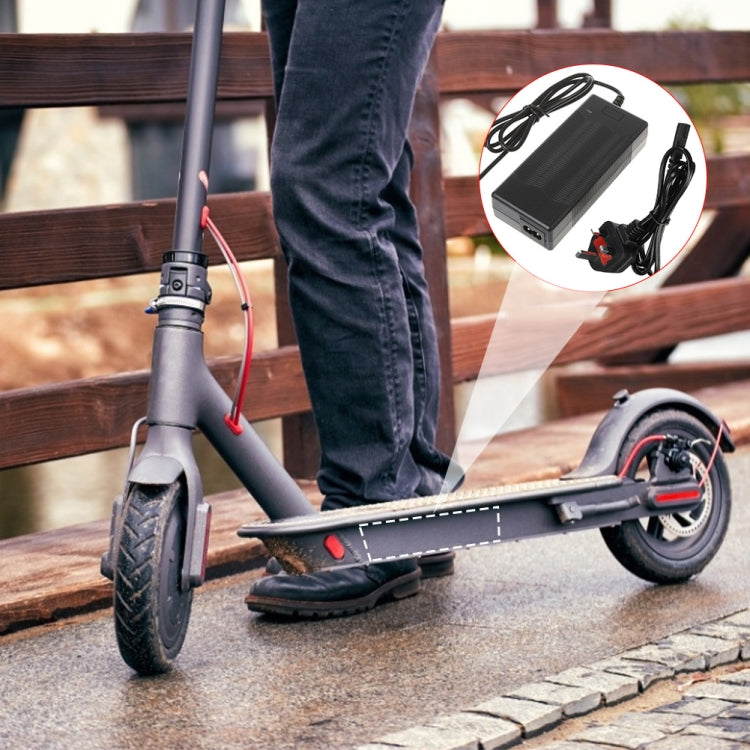 Electric scooter with connected charger shown in inset