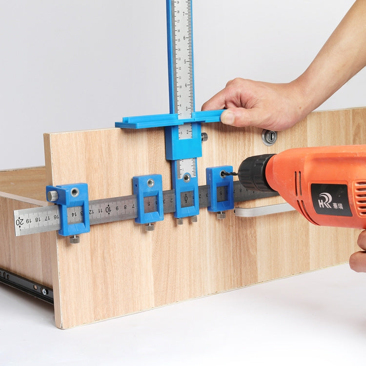 Woodworking hole locator jig in use with blue rails on a wooden board