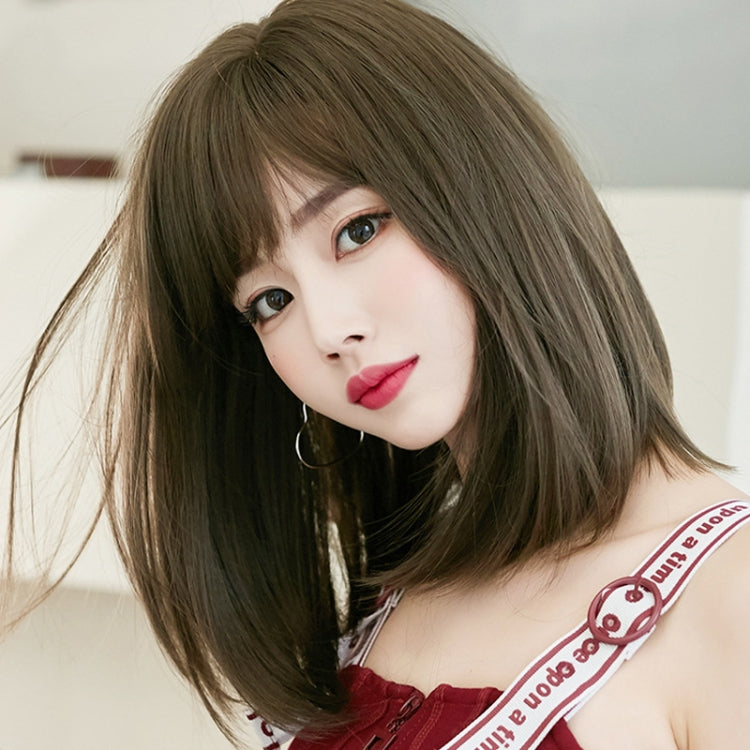 Women’s medium-length realistic bob wig worn on model, side-swept bangs, brown