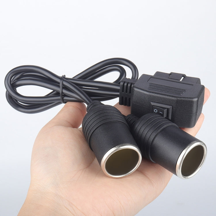 Car OBD power cord with switch and two lighter outlets, held in hand