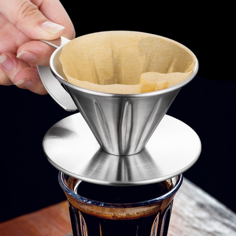 Stainless steel pour-over coffee filter with paper liner, held by side handle