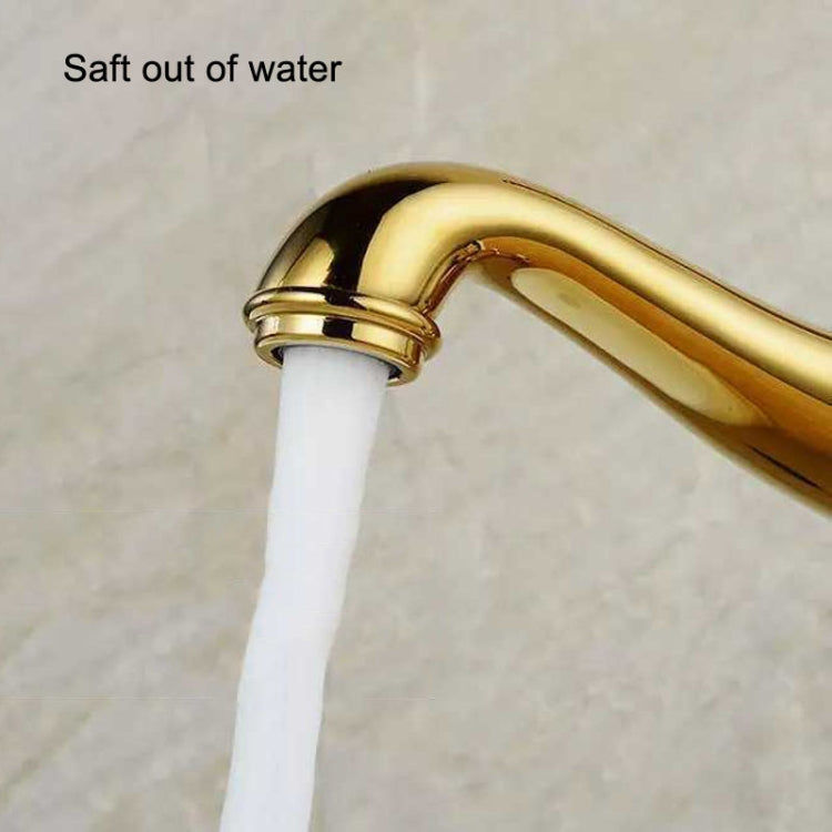 Gold faucet spout with white outlet tube, close-up