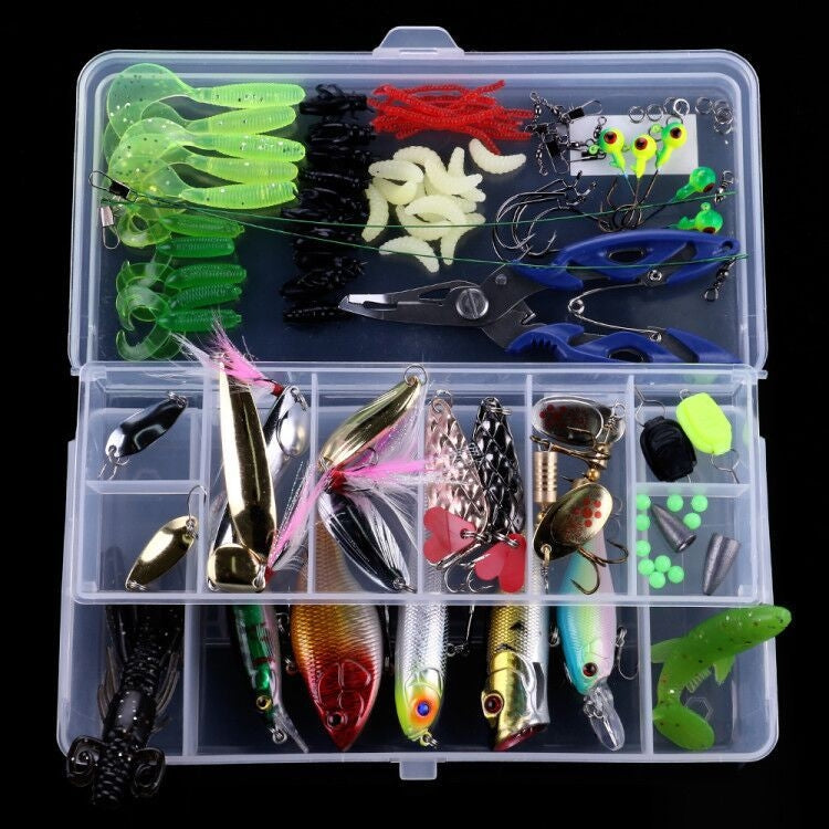 Clear tackle box with mixed fishing lures, spinner baits, soft baits, and hook accessories