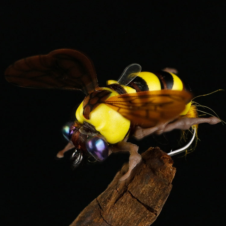 Fake floating bee bait close-up with yellow/black stripes and translucent wings