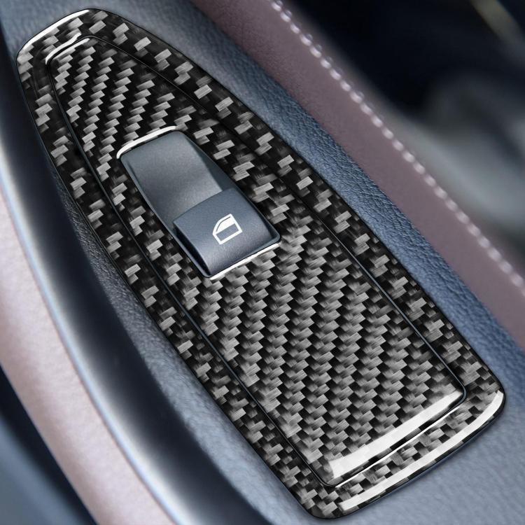 Close-up of carbon-fiber door control switch sticker insert with glossy trim
