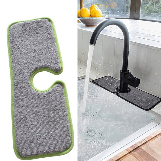 Gray basin drain absorbent pad with green border and oval cutout, wraparound sink mat.