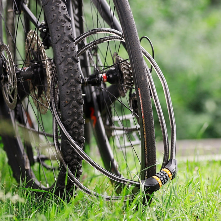 Bicycle with black coiled cable lock looped around tire and frame