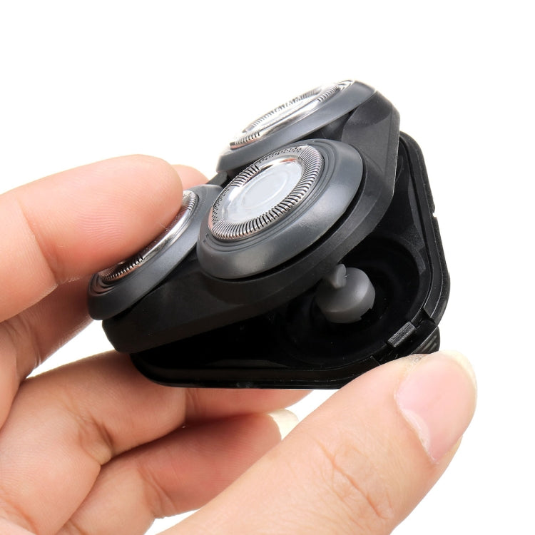 Replacement shaver head detail, round blade and grille on black housing