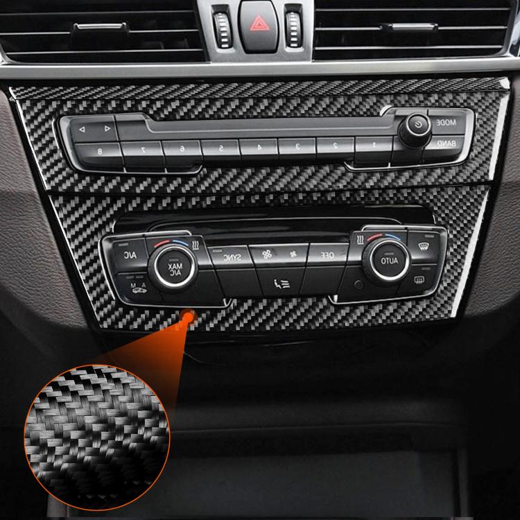 Installed carbon fiber trim sticker set around dashboard controls and radio panel