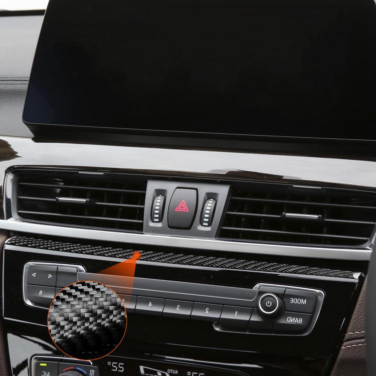 Carbon fiber radio panel trim sticker on vent controls, partial close-up