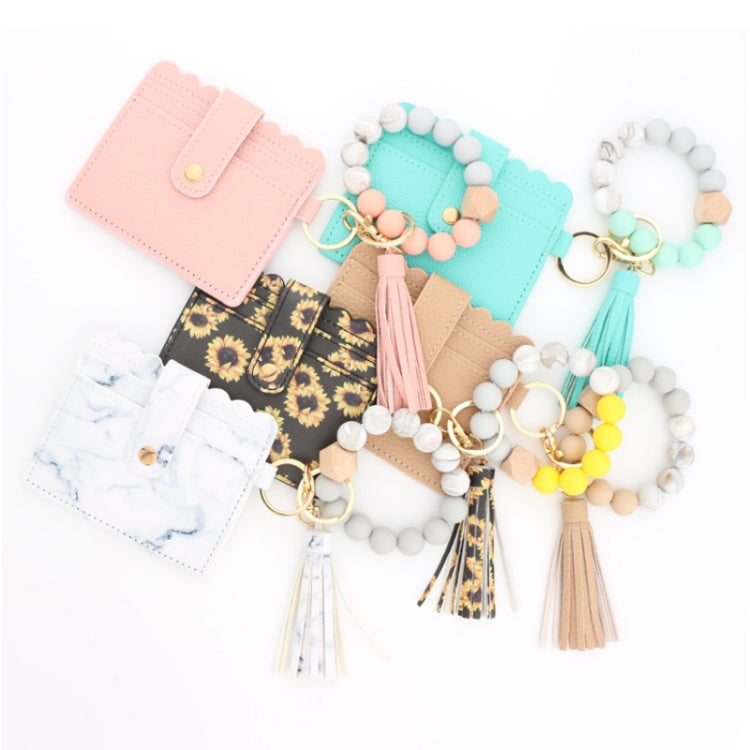 Assorted beaded keychain wallets with tassels, including floral and pastel pouch designs