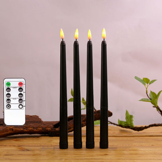 Set of 4 black LED pillar candles with flickering flame tips and included remote control