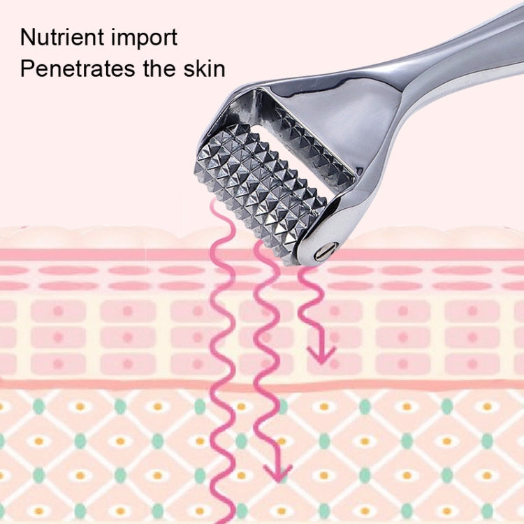 Close-up of chrome needle roller face massager showing textured barbed head