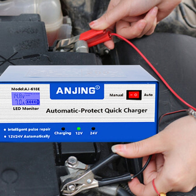 Automatic battery quick charger connected to a car battery with red clamp