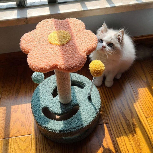 Small cat turntable scratching board with pink plush top and hanging pom balls