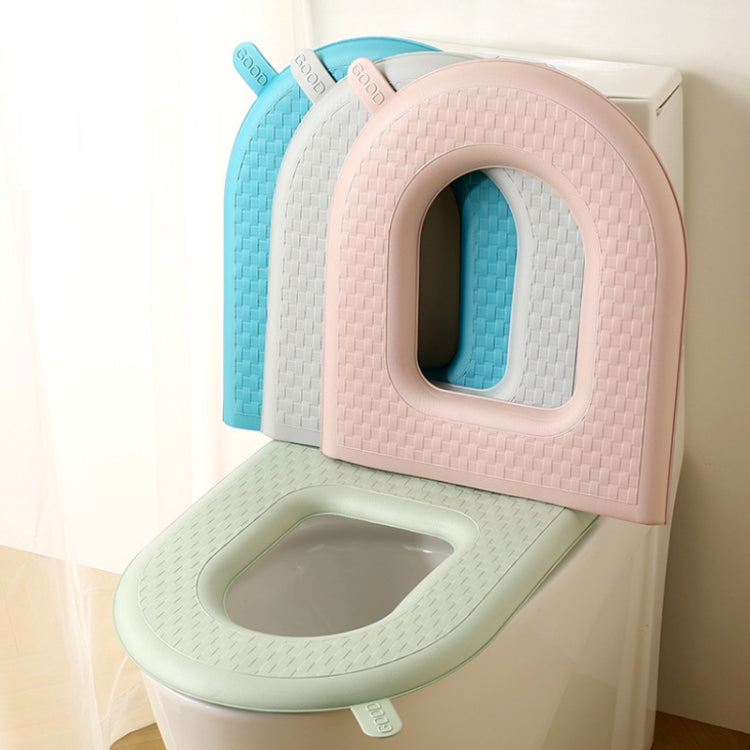 Pack of toilet seat covers in green, blue, white, and pink with oval openings