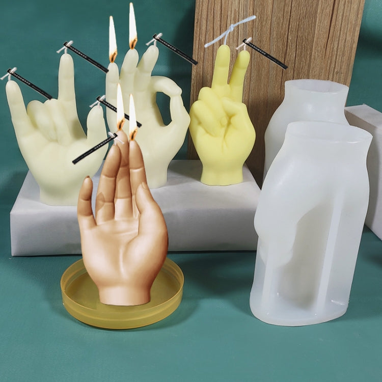 Set of hand-shaped silicone candle molds and finished hand candles