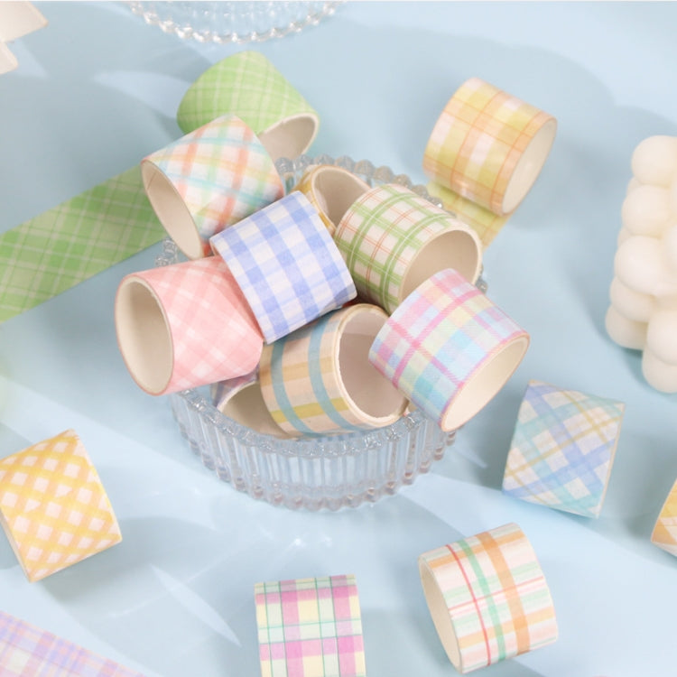 Mixed pastel plaid lattice washi tape rolls spilling from a decorative tray