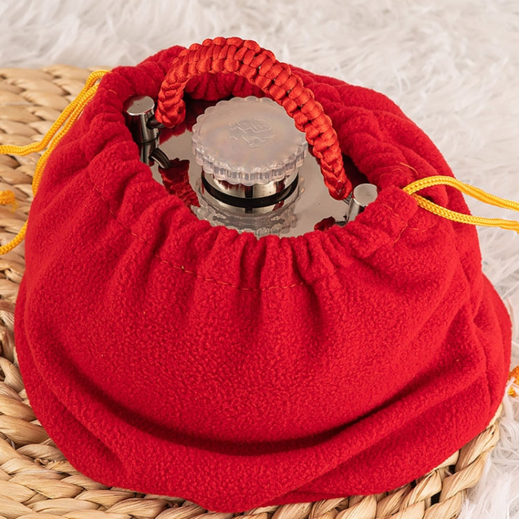 Stainless steel hot water bottle in red fabric pouch with drawstring and braided handle