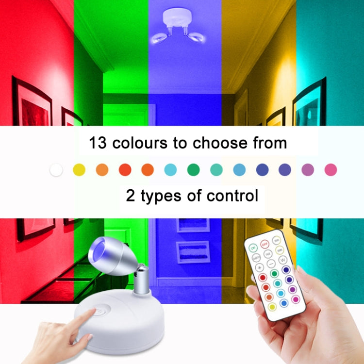 Wireless RGB cabinet spotlight with remote, silver head projecting multicolor light