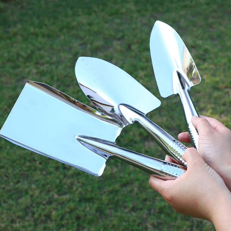 Stainless steel shovel set held by hand with polished wide and pointed blades