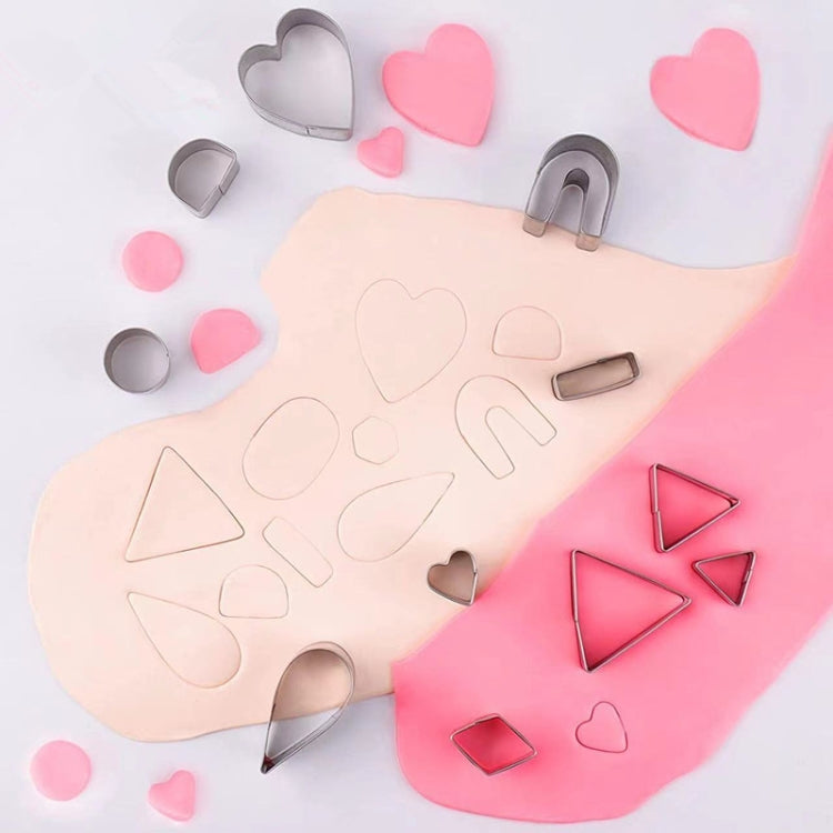 Assorted metal polymer clay earring cutters, heart and arch shapes on pink backgrounds