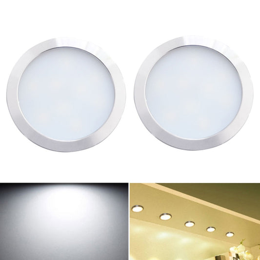 Set of 2 round recessed LED cabinet lights with silver metal trim, cool white glow