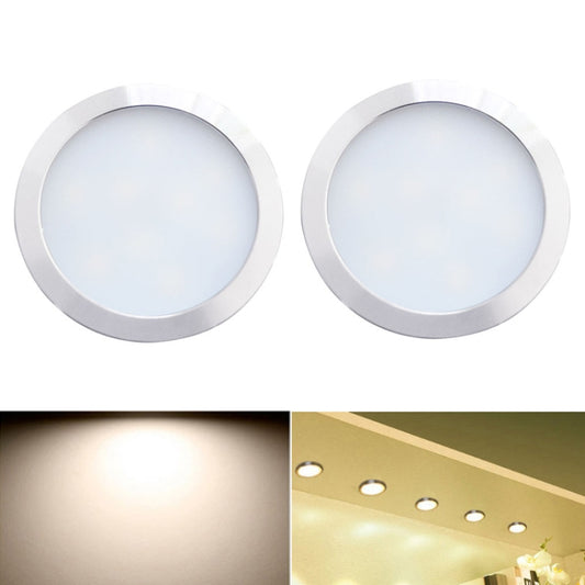 Set of 2 round recessed LED cabinet lights with silver metal trim, warm white glow