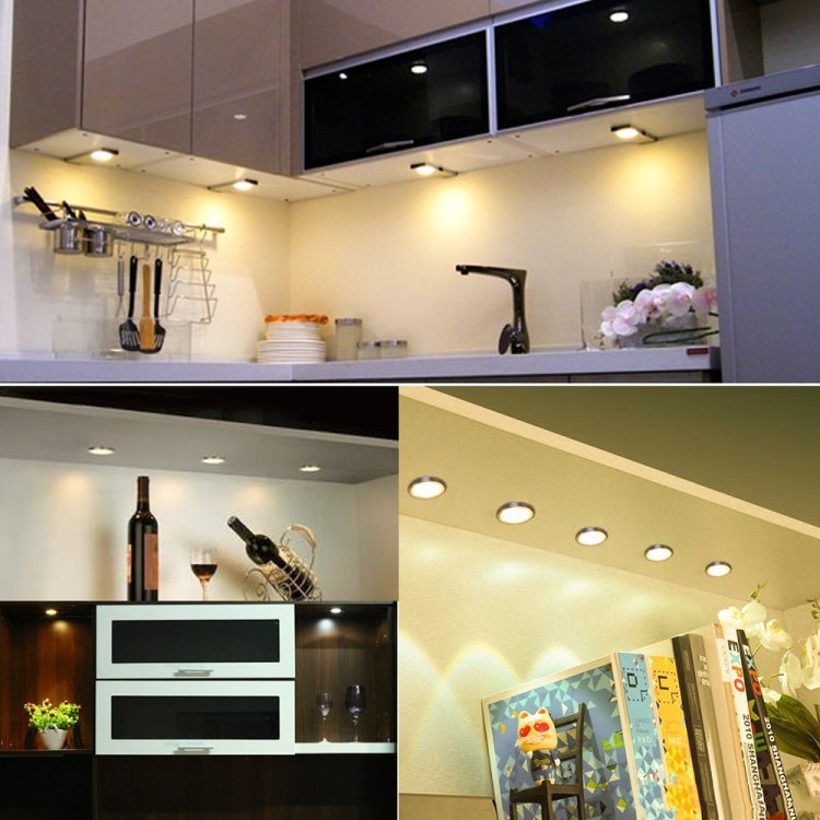 Under-cabinet LED lighting set with multiple small round puck lights installed