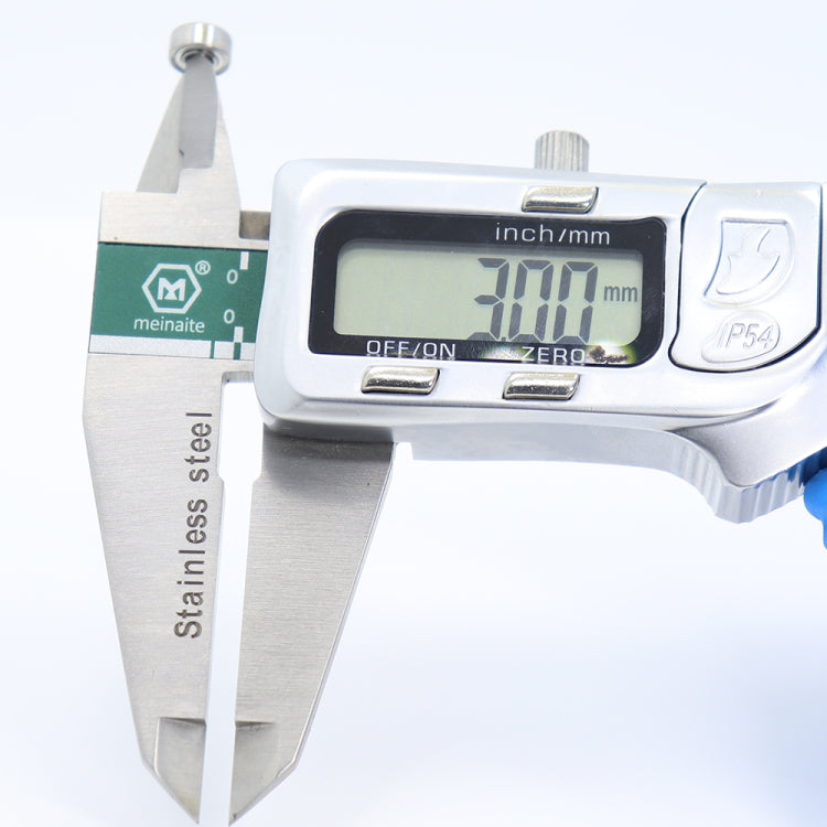 Miniature shielded ball bearing with digital caliper measuring distance