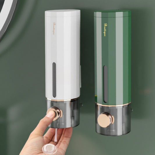 Wall-mounted liquid soap dispensers in white and dark green with rose-gold pump buttons