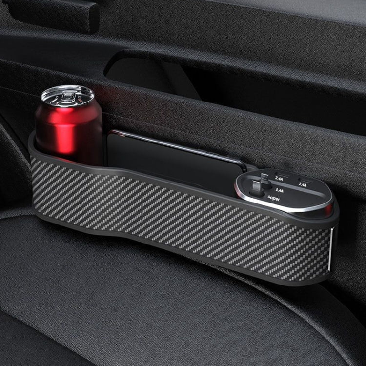 Car seat clip organizer tray with carbon-fiber pattern and charging base beside drink can