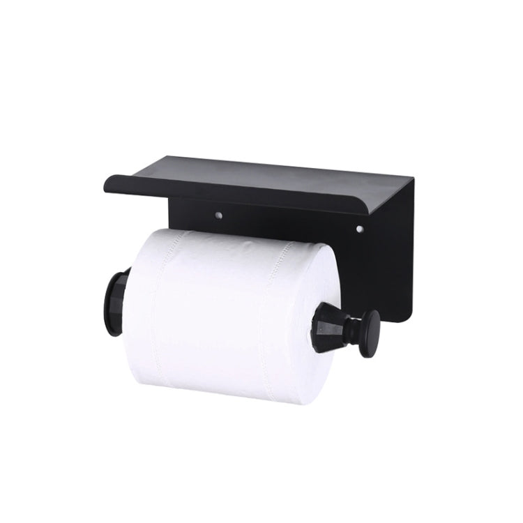 Black metal paper towel roll holder rack holding a white paper towel roll