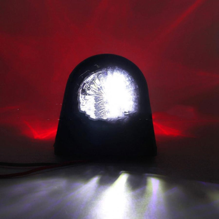 Truck side marker light emitting bright white LEDs from clear lens, black housing