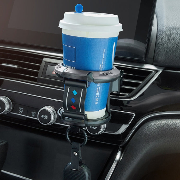 Car cup holder accessory holding a disposable drink cup on the dashboard vent