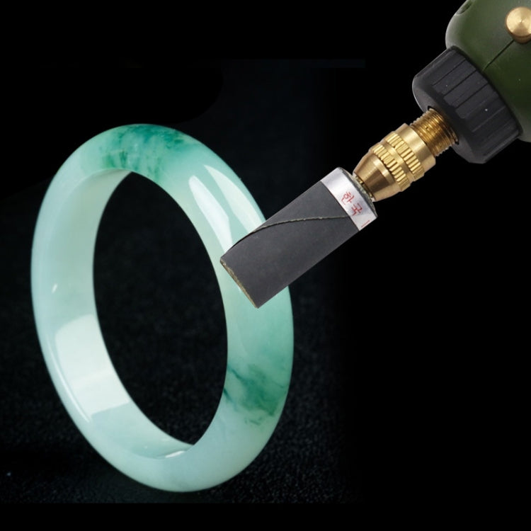 Mirror polishing paper stick with dark abrasive tip used on light blue ring surface