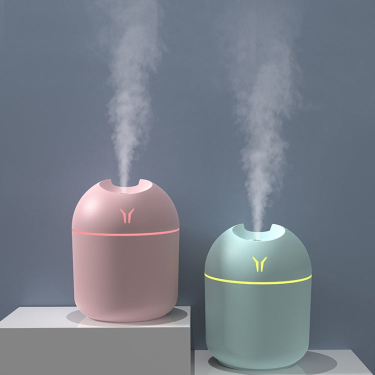 Colorful mini desktop humidifier night lights, pink and blue with mist.