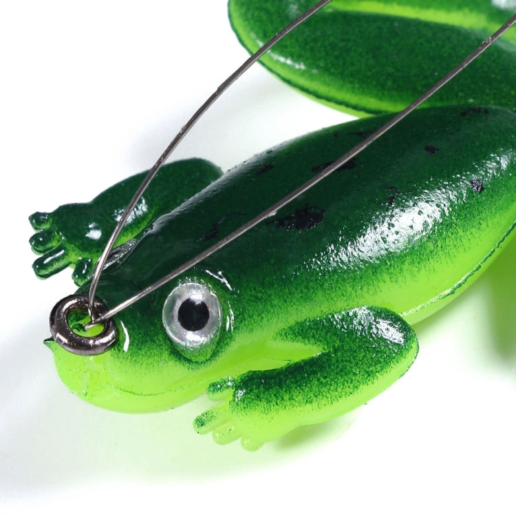 Close-up green frog floating fishing lure with treble hooks and glossy finish