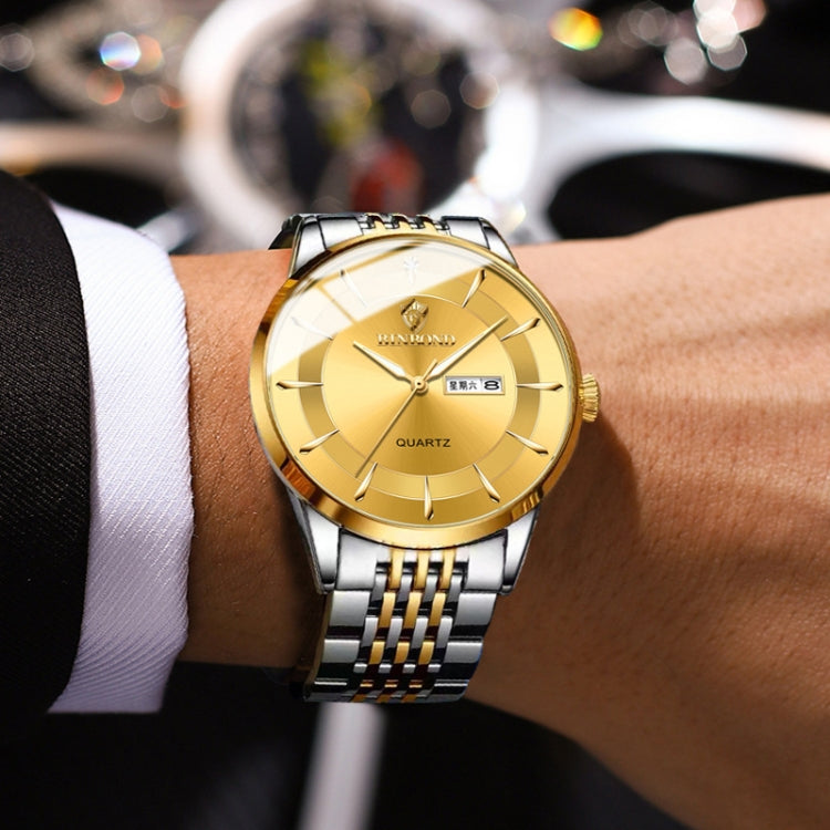 Men's steel quartz watch on wrist with gold dial and two-tone metal bracelet