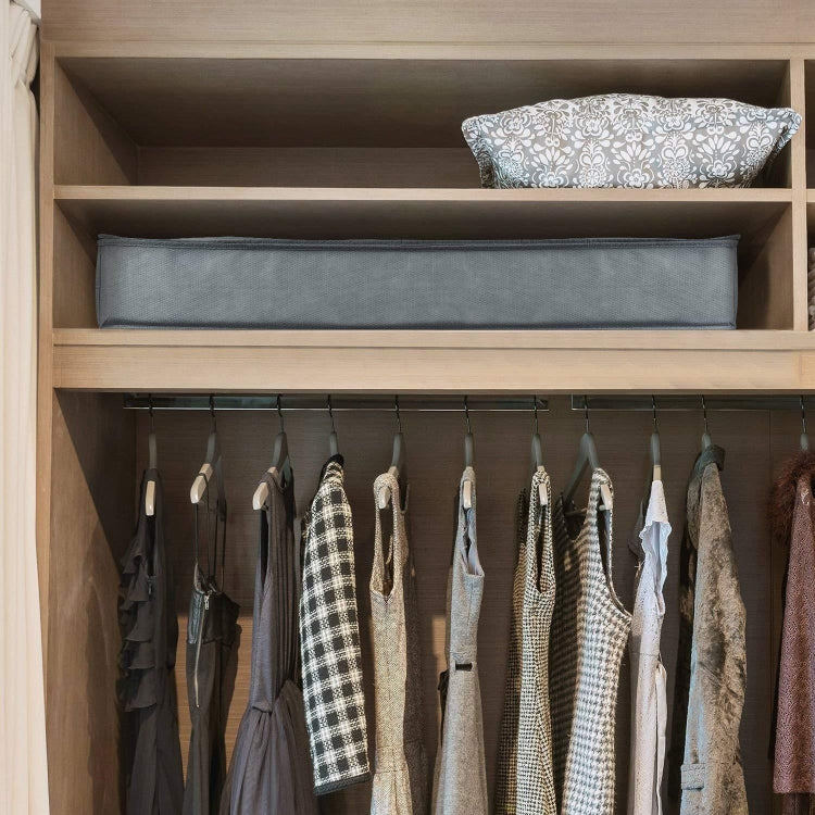 Gray quilt storage bag on a closet shelf for storing folded linens