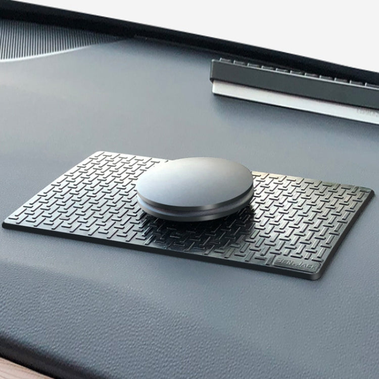 Black anti-skid dashboard mat with circular phone mount on textured pattern