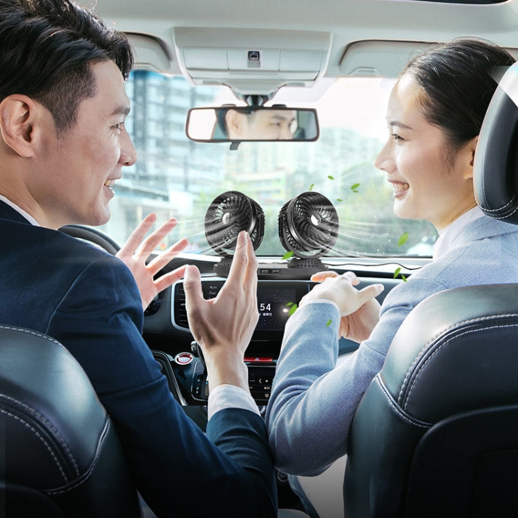 Dual-head oscillating car fan with two circular black fan grilles in cabin