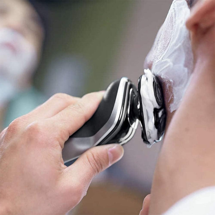 Razor head replacement being attached to electric shaver with metal foil blades