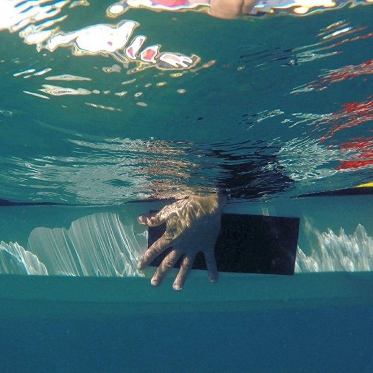 Waterproofing tape sealing a leak under water, black patch held by hand
