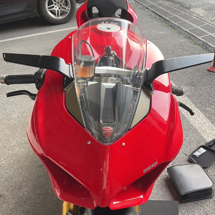 Installed motorcycle fixed-wing reflectors on front fairing, black frames with light panels.